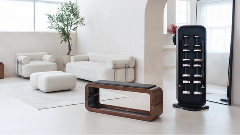 A modern minimalist living room featuring the NOHRD StepTower with multiple round dumbbells, ready for an at-home gym session.