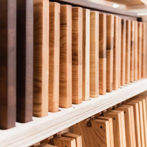 A close-up of wood in the NOHRD factory, ready to be turned into wooden gym equipment.